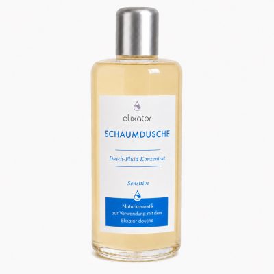 Bottle of Elixator Schaumdusche shower foam concentrate for sensitive skin with a white label and blue text, clear bottle with silver cap.