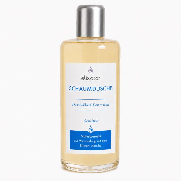 Bottle of Elixator Schaumdusche shower foam concentrate for sensitive skin with a white label and blue text, clear bottle with silver cap.