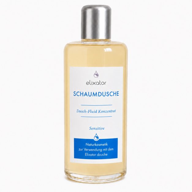 Bottle of Elixator Schaumdusche shower foam concentrate for sensitive skin with a white label and blue text, clear bottle with silver cap.