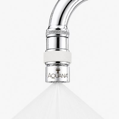 Close-up of a chrome faucet sprayer releasing a fine spray, with the Aquana logo visible on the nozzle.