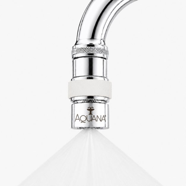 Close-up of a chrome faucet sprayer releasing a fine spray, with the Aquana logo visible on the nozzle.